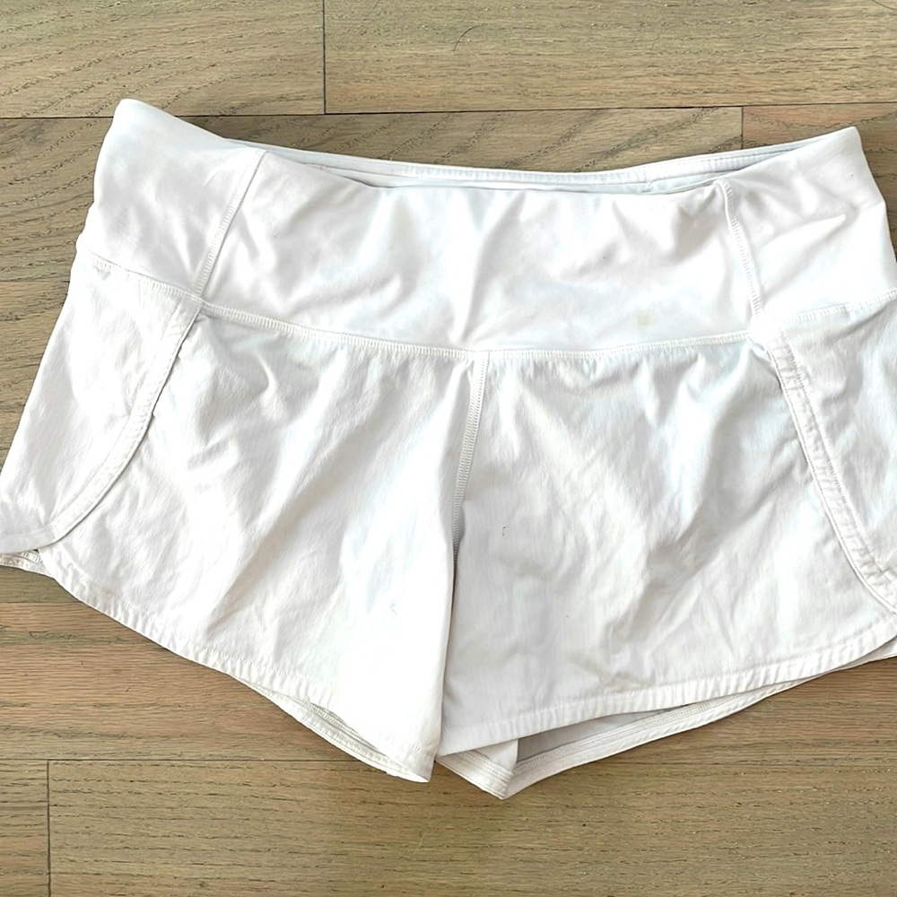White Lululemon athletic shorts size 6, four inch inseam. Good condition!